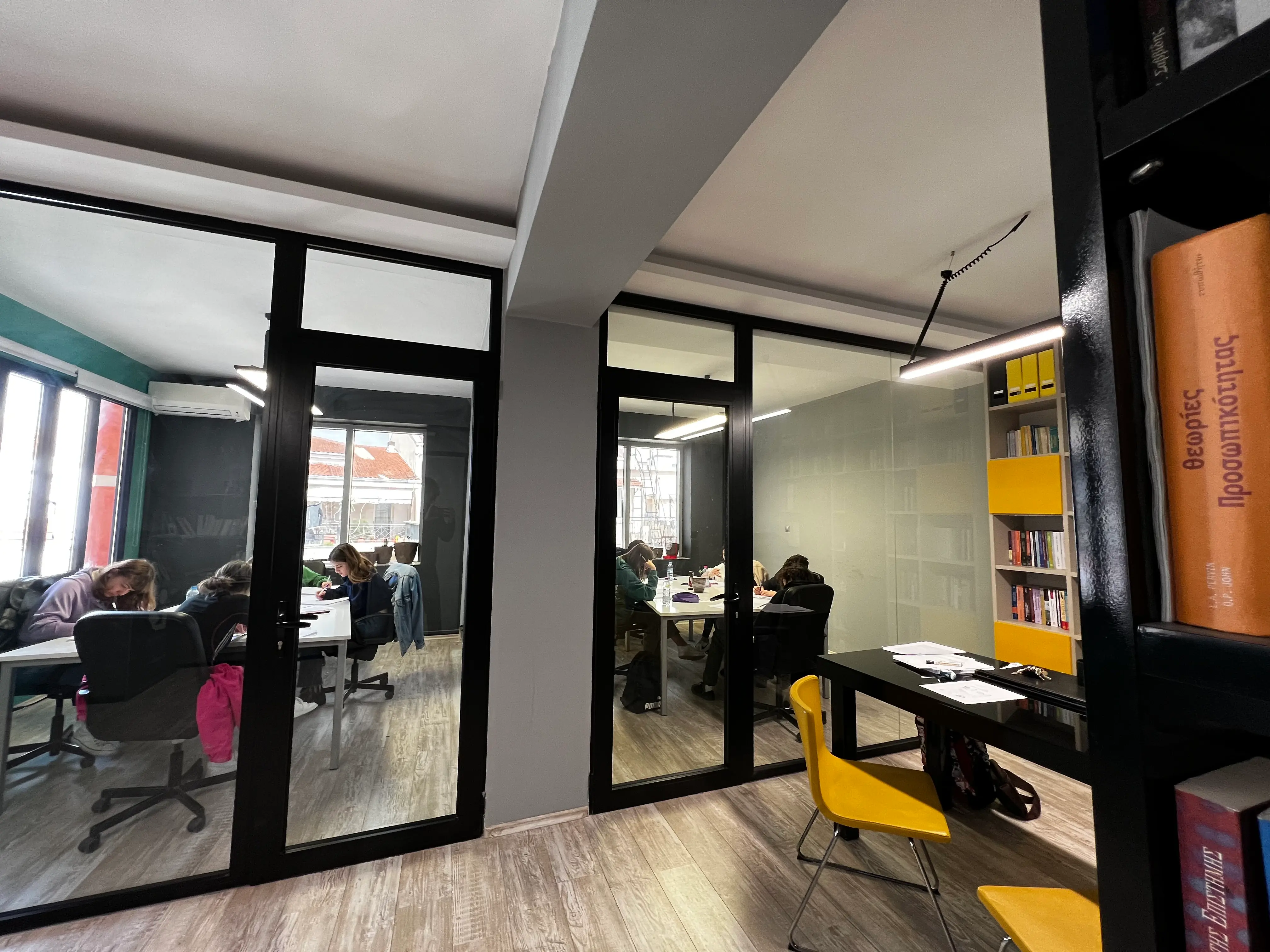 The glass classrooms at Exelixi For Minds during a study session.